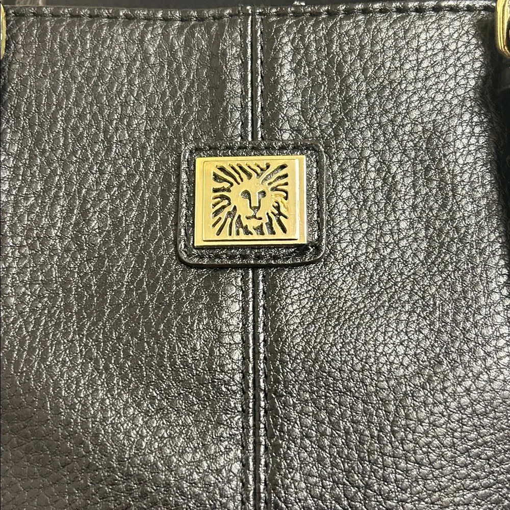 Anne Klein Black leather Tote with size pocket and adjustable straps. 13”x9 1/2”